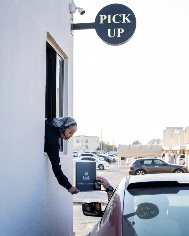 A coffee handed out of the drive-thru window